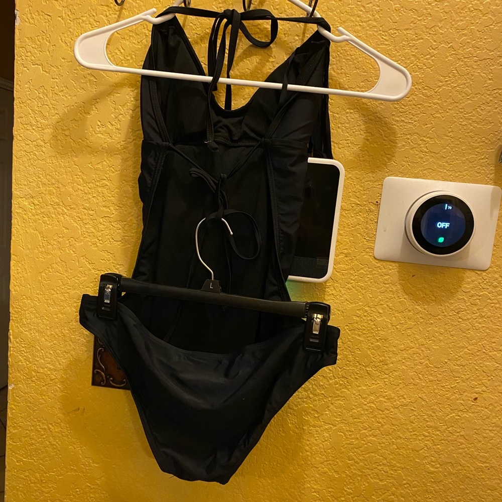 V28 Black one piece with hanging fringe hanging from top.
